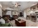 Open-concept living space featuring leather sofas, tile flooring, and a breakfast bar at 265 E Liberty Ln, Gilbert, AZ 85296