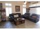 Inviting living room with leather sofas, tile flooring, and bright windows offering ample natural light at 265 E Liberty Ln, Gilbert, AZ 85296