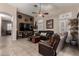 Inviting living room featuring a comfortable leather sofa and a stylish ceiling fan at 265 E Liberty Ln, Gilbert, AZ 85296