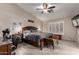 A large main bedroom featuring a seating area, ceiling fan, and neutral-colored walls at 265 E Liberty Ln, Gilbert, AZ 85296
