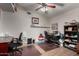Functional home office setup with a large desk, chair and shelf space at 265 E Liberty Ln, Gilbert, AZ 85296