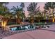 Backyard pool area showcasing a tranquil in-ground pool with rock waterfall feature, palm trees at 265 E Liberty Ln, Gilbert, AZ 85296