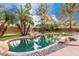 Backyard pool area showcasing a tranquil in-ground pool with rock waterfall feature at 265 E Liberty Ln, Gilbert, AZ 85296
