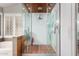 Modern bathroom featuring a glass-enclosed shower with wood accents and dual showerheads at 265 E Liberty Ln, Gilbert, AZ 85296