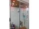 Modern glass-enclosed shower with a rainfall showerhead, body jets, and a wooden floor at 265 E Liberty Ln, Gilbert, AZ 85296
