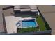 Aerial view showcasing a backyard pool and spa, seamlessly integrated with the home's outdoor living space at 28304 N 141St Way, Scottsdale, AZ 85262