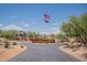 Circular driveway entrance featuring an American flag and Arizona state flag waving on a tall flagpole at 28304 N 141St Way, Scottsdale, AZ 85262