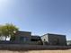 Contemporary home showcasing a sleek gray facade, complemented by desert landscaping and a low brick wall at 28304 N 141St Way, Scottsdale, AZ 85262