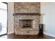 Close up of a stone fireplace with a wooden mantle and gas insert at 28304 N 141St Way, Scottsdale, AZ 85262