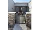 Stylish courtyard entrance features a decorative metal gate and stone pillars, leading to a welcoming seating area at 28304 N 141St Way, Scottsdale, AZ 85262