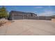 Exterior view of a large three-car garage with a concrete driveway and a gated entry at 28304 N 141St Way, Scottsdale, AZ 85262