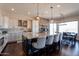 Open kitchen with a large island, bar stool seating, and modern stainless steel appliances at 28304 N 141St Way, Scottsdale, AZ 85262