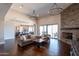 Bright living room with hardwood floors, stone fireplace, open to kitchen and covered patio at 28304 N 141St Way, Scottsdale, AZ 85262
