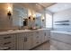Elegant bathroom featuring double sinks, subway tile, and soaking tub at 28304 N 141St Way, Scottsdale, AZ 85262