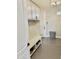 Neutral mud room features storage cabinets, a bench with open shelving, and gray tiling at 28304 N 141St Way, Scottsdale, AZ 85262