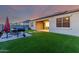 Backyard with artificial turf, barbecue grill, and outdoor seating area, perfect for entertaining at 30071 W Indianola Ave, Buckeye, AZ 85396