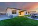 Backyard with solar panels, artificial turf, and a patio with an outdoor seating area at 30071 W Indianola Ave, Buckeye, AZ 85396