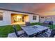 Backyard with artificial turf, patio, and outdoor seating, visible through the sliding glass door from the living room at 30071 W Indianola Ave, Buckeye, AZ 85396