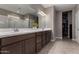 Spacious bathroom with double sinks, a large mirror, and a walk-in closet at 30071 W Indianola Ave, Buckeye, AZ 85396