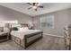 Comfortable bedroom boasts plush carpet, neutral walls, and a decorative ceiling fan at 30071 W Indianola Ave, Buckeye, AZ 85396