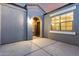 Charming home entryway with a decorative 'Home Sweet Home' sign and a warmly lit arched entrance at 30071 W Indianola Ave, Buckeye, AZ 85396