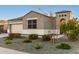 Charming single-story home showcasing a well-maintained front yard with desert landscaping and a decorative gate at 30071 W Indianola Ave, Buckeye, AZ 85396