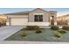 Charming single-story home showcasing a well-maintained front yard with desert landscaping and a two car garage at 30071 W Indianola Ave, Buckeye, AZ 85396