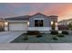 Charming single-story home showcasing a well-maintained front yard with desert landscaping and a two car garage at 30071 W Indianola Ave, Buckeye, AZ 85396