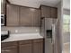 Modern kitchen features sleek cabinets, stainless steel refrigerator, and quartz countertops at 30071 W Indianola Ave, Buckeye, AZ 85396