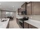 Kitchen featuring stainless appliances, an island with seating and a view to the dining area at 30071 W Indianola Ave, Buckeye, AZ 85396