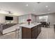 Bright kitchen featuring a kitchen island, stainless appliances, and an open floor plan at 30071 W Indianola Ave, Buckeye, AZ 85396