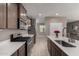 Modern kitchen with stainless steel appliances, a kitchen island, and a view of a dining area at 30071 W Indianola Ave, Buckeye, AZ 85396