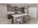 Kitchen features stainless appliances, a large island with bar stool seating, and bright white countertops at 30071 W Indianola Ave, Buckeye, AZ 85396