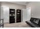 Relaxing living room is complete with a futon, wall art, and a shelf at 30071 W Indianola Ave, Buckeye, AZ 85396