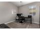 Functional home office featuring carpeted floor, a window, and dark-colored furniture at 30071 W Indianola Ave, Buckeye, AZ 85396