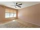 Neutral bedroom with a large window, carpet flooring, and natural light at 303 W Thompson Pl, Chandler, AZ 85286