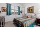 Bedroom featuring a decorative metal bed frame, patterned bedding, and carpeted floors at 3202 N 197Th Ave, Buckeye, AZ 85396