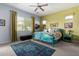 Cozy bedroom with ceiling fan, natural light, and unique decor at 3202 N 197Th Ave, Buckeye, AZ 85396