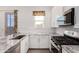 Well-equipped kitchen featuring granite counters, stainless steel appliances, and white cabinetry for a sleek, modern look at 3202 N 197Th Ave, Buckeye, AZ 85396