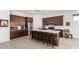 Modern kitchen with dark wood cabinetry, stainless steel appliances, and a brick-accented island at 3202 N 197Th Ave, Buckeye, AZ 85396