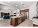 Well-lit kitchen featuring stainless steel appliances and a granite countertop island at 3202 N 197Th Ave, Buckeye, AZ 85396