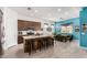 Well-lit kitchen featuring a large island with seating, stainless steel appliances, and tile flooring at 3202 N 197Th Ave, Buckeye, AZ 85396