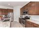 Modern kitchen featuring stainless steel appliances, granite countertops, and ample cabinetry at 3202 N 197Th Ave, Buckeye, AZ 85396