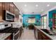 This is an open kitchen with stainless steel appliances and granite countertops looking out to the dining area and backyard at 3202 N 197Th Ave, Buckeye, AZ 85396