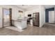 The kitchen features stainless steel appliances, granite countertops, subway tile backsplash, and a cozy breakfast bar at 3202 N 197Th Ave, Buckeye, AZ 85396
