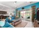 Bright and airy living room with a blue sofa, area rug, and sliding glass doors leading to the outdoor patio at 3202 N 197Th Ave, Buckeye, AZ 85396