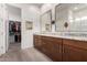 Spacious main bathroom with dual sinks, granite countertops, and a walk-in closet at 3202 N 197Th Ave, Buckeye, AZ 85396