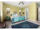 Bright main bedroom showcasing a colorful bed frame, ceiling fan, and carpeted floor at 3202 N 197Th Ave, Buckeye, AZ 85396