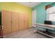 Bright home office space with custom storage cabinets, a desk, and tile flooring at 3202 N 197Th Ave, Buckeye, AZ 85396