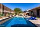 Backyard oasis featuring a sparkling swimming pool, lounge chairs, and a painted privacy wall at 3202 N 197Th Ave, Buckeye, AZ 85396